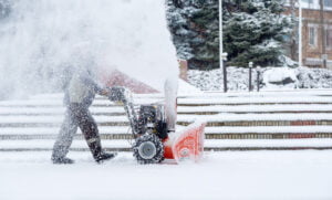 snow-removal-work-with-snow-blower-man-removing-snow-heavy-precipitation-snow-piles